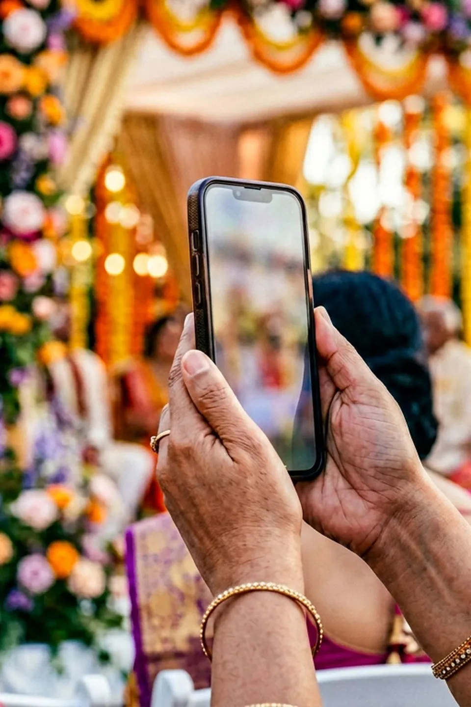 Guest viewing celebration details on a phone, editorial photograph